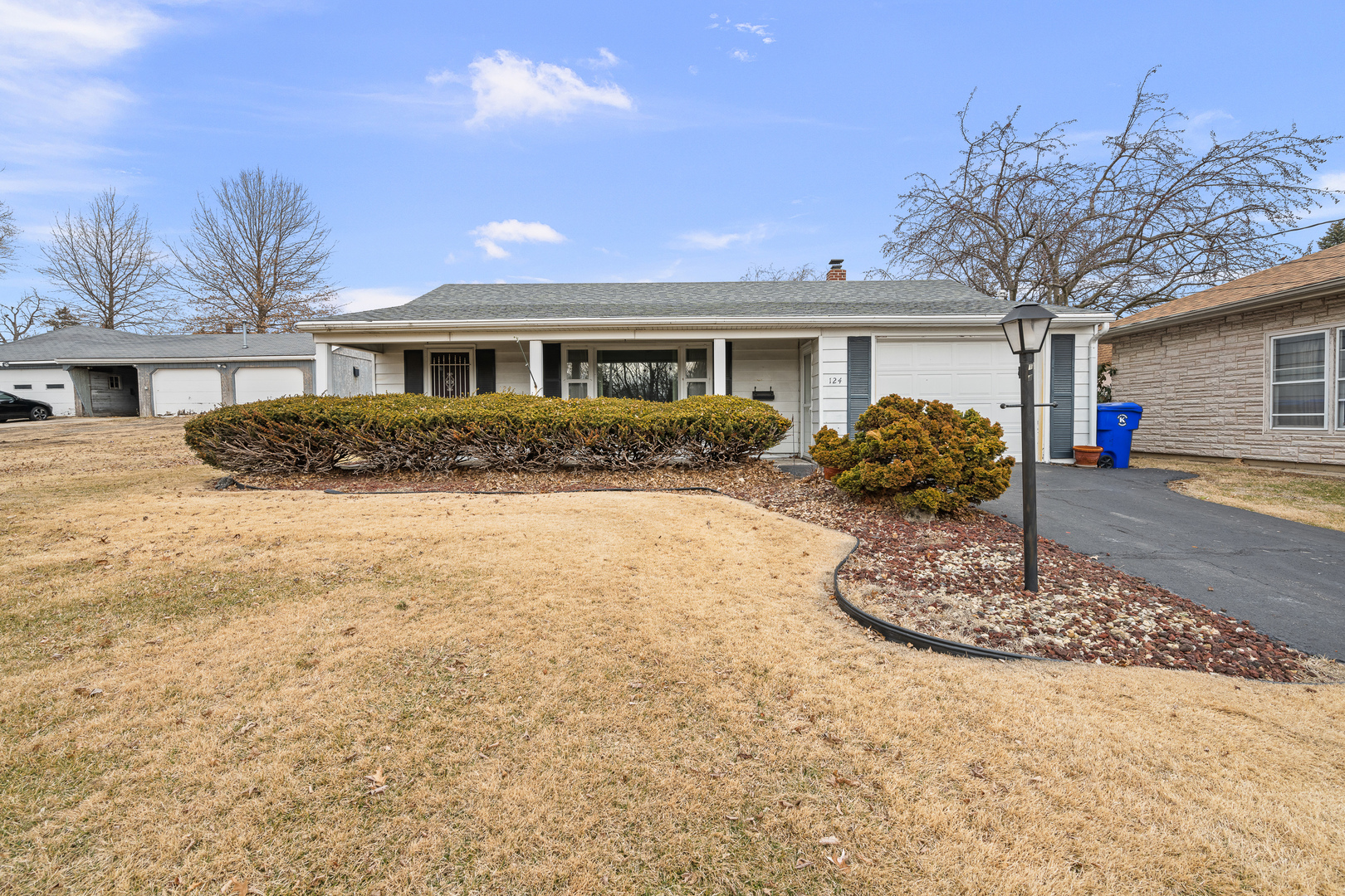 124 East Mill Street Kewanee, IL 61443 - Photo 1 of 21 a front view of a house with a yard and potted plants
