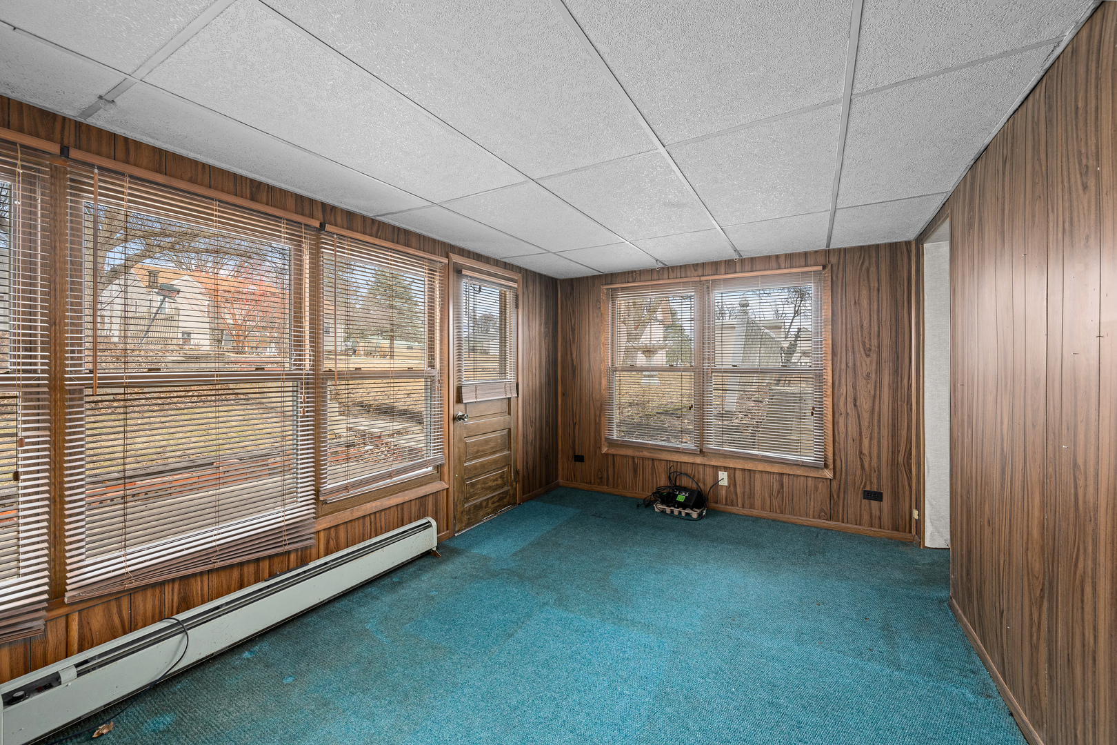 124 East Mill Street Kewanee, IL 61443 - Photo 15 of 21 a view of an empty room with wooden floor and a window