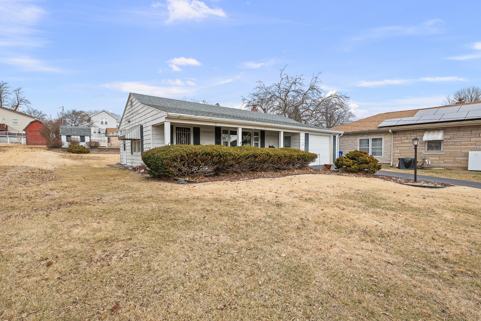 124 East Mill Street Kewanee, IL 61443 - Photo 16 of 21 a front view of house with yard and trees in the background