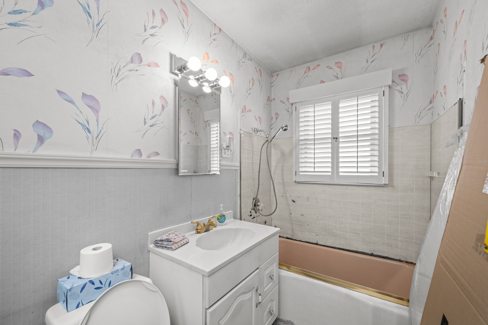 124 East Mill Street Kewanee, IL 61443 - Photo 8 of 21 a bathroom with a sink a toilet and vanity