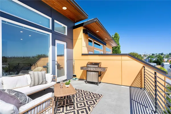 a kitchen with stainless steel appliances a table chairs and refrigerator