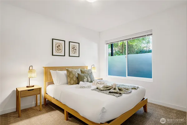 a bedroom with a bed and lamp