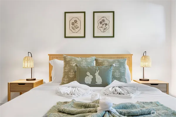 a bedroom with a bed and a night stand