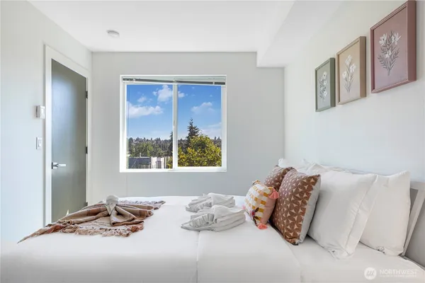 a bedroom with a bed and a window