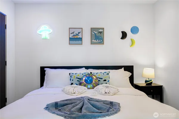 a bedroom with a bed and a wall painting