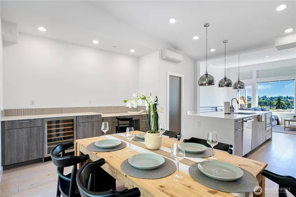 a open dining room with furniture and wooden floor