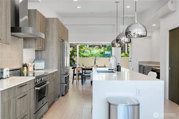 a kitchen with stainless steel appliances granite countertop a stove and a refrigerator