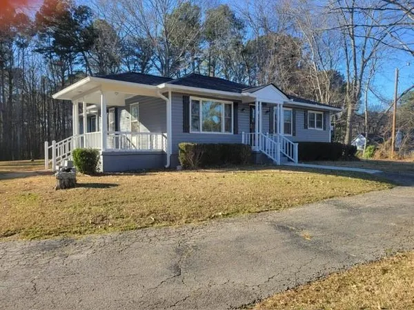 a front view of a house with a yard outdoor seating and barbeque oven