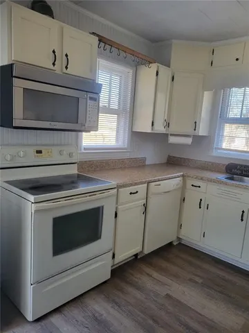 a kitchen with cabinets appliances and a sink