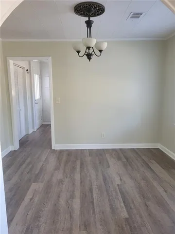 a view of a room with wooden floor and carpet