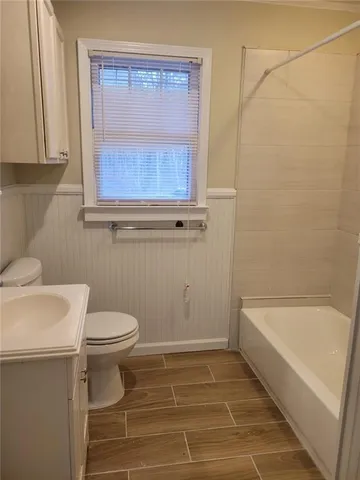 a bathroom with a toilet a sink and a bathtub
