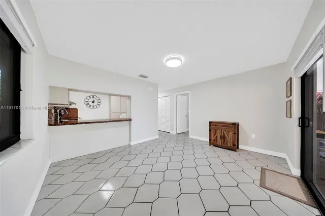 a view of a room with window and hardwood