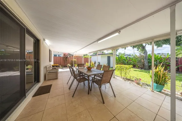 a dining room with furniture and a garden view