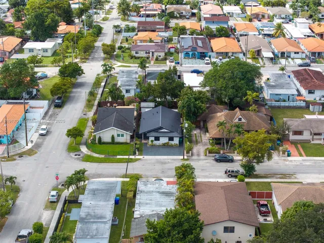 an aerial view of residential houses with outdoor space