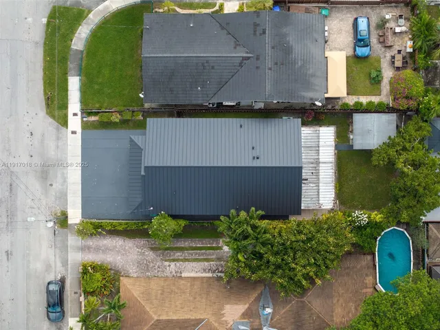 an aerial view of a house with a yard and a fountain