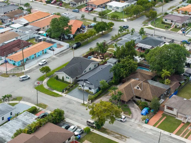 an aerial view of residential houses with outdoor space