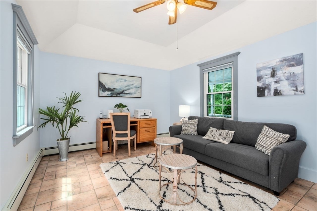 19 Brady Loop Andover, MA 01810 - Photo 18 of 35 a living room with furniture and a chandelier
