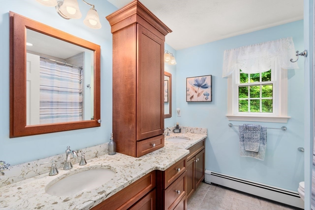19 Brady Loop Andover, MA 01810 - Photo 25 of 35 a bathroom with a granite countertop double vanity sink a mirror and a window