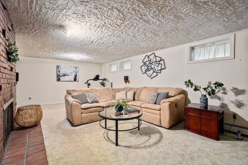 19 Brady Loop Andover, MA 01810 - Photo 27 of 35 a living room with furniture a rug and a table