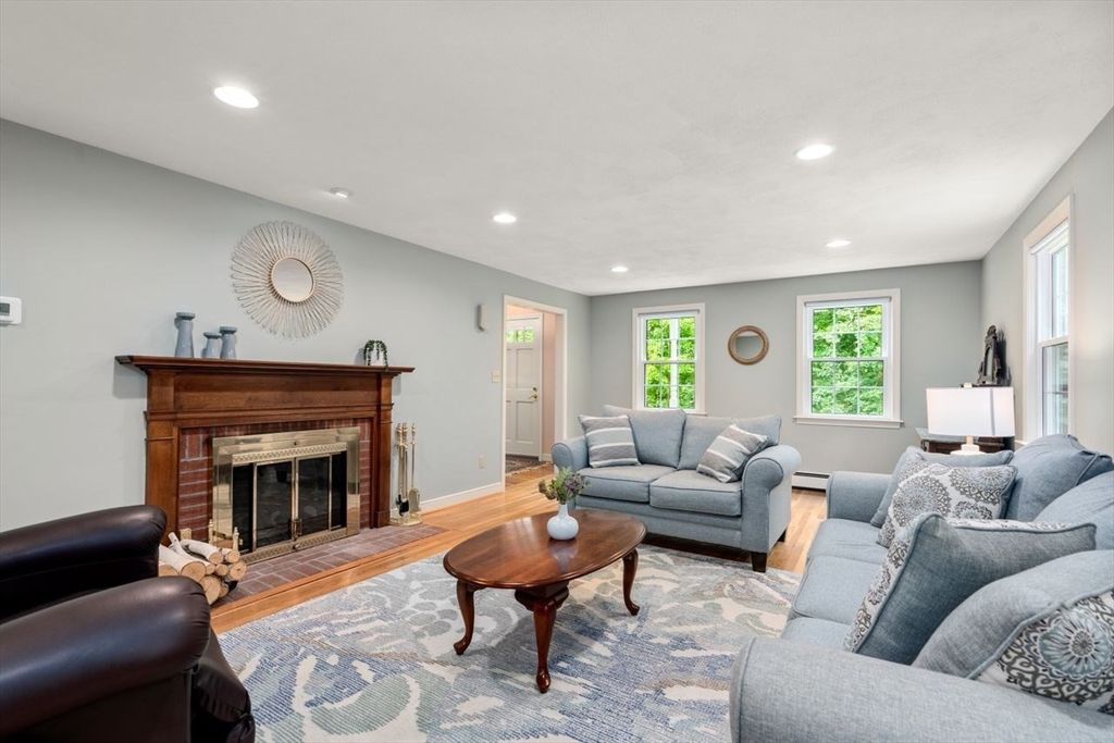 19 Brady Loop Andover, MA 01810 - Photo 7 of 35 a living room with furniture and a fireplace
