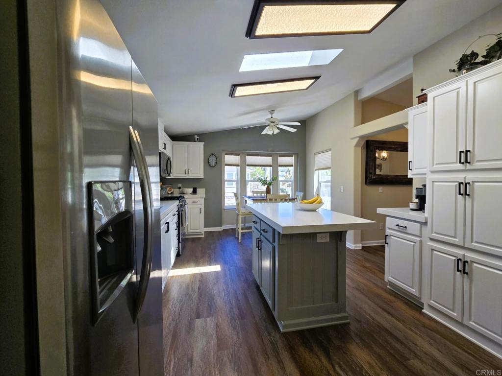 2239 Black Canyon Road, Unit 55 Ramona, CA 92065 - Photo 13 of 38 a kitchen with stainless steel appliances granite countertop a refrigerator a sink dishwasher a stove and white countertops with wooden floor