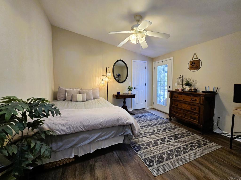 2239 Black Canyon Road, Unit 55 Ramona, CA 92065 - Photo 15 of 38 a bedroom with a bed and wooden floor