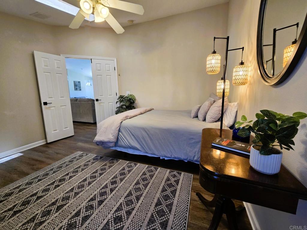 2239 Black Canyon Road, Unit 55 Ramona, CA 92065 - Photo 16 of 38 a bedroom with a bed and a chandelier