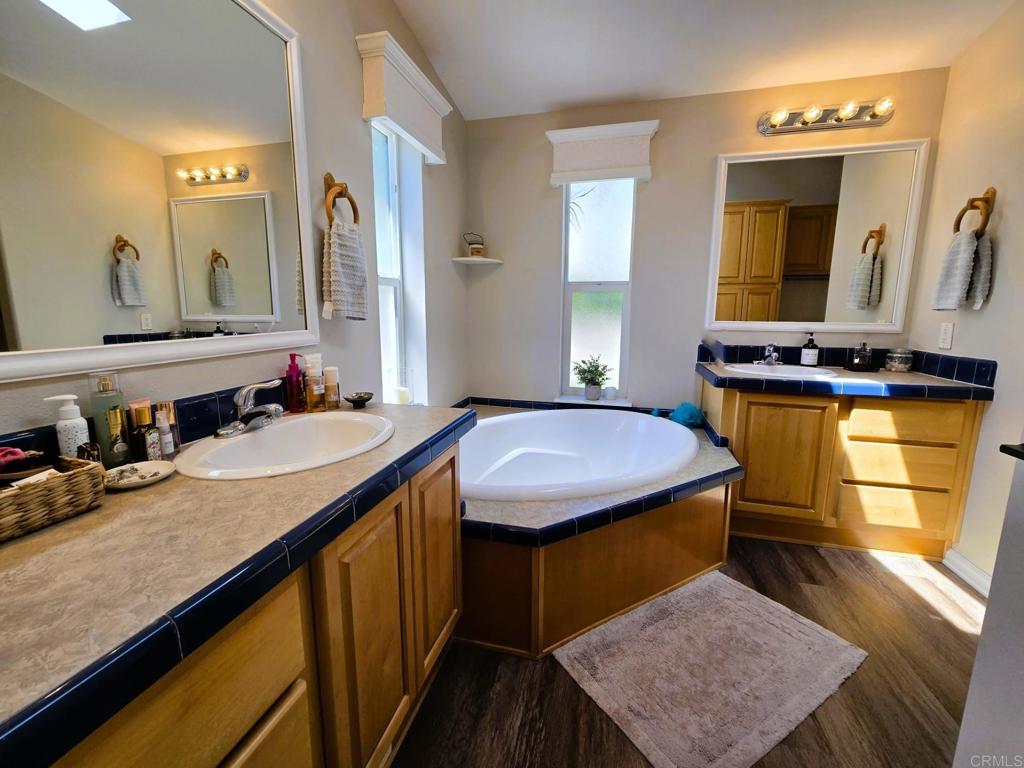 2239 Black Canyon Road, Unit 55 Ramona, CA 92065 - Photo 21 of 38 a bathroom with a granite countertop sink a mirror and vanity