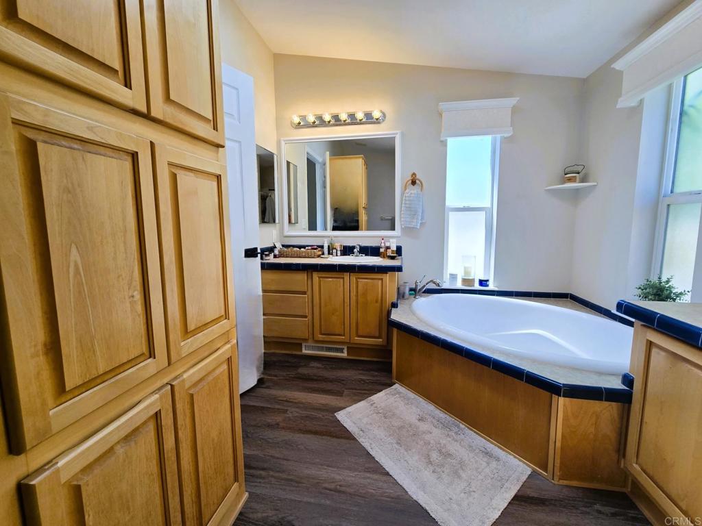 2239 Black Canyon Road, Unit 55 Ramona, CA 92065 - Photo 23 of 38 a bathroom with a tub sink and mirror