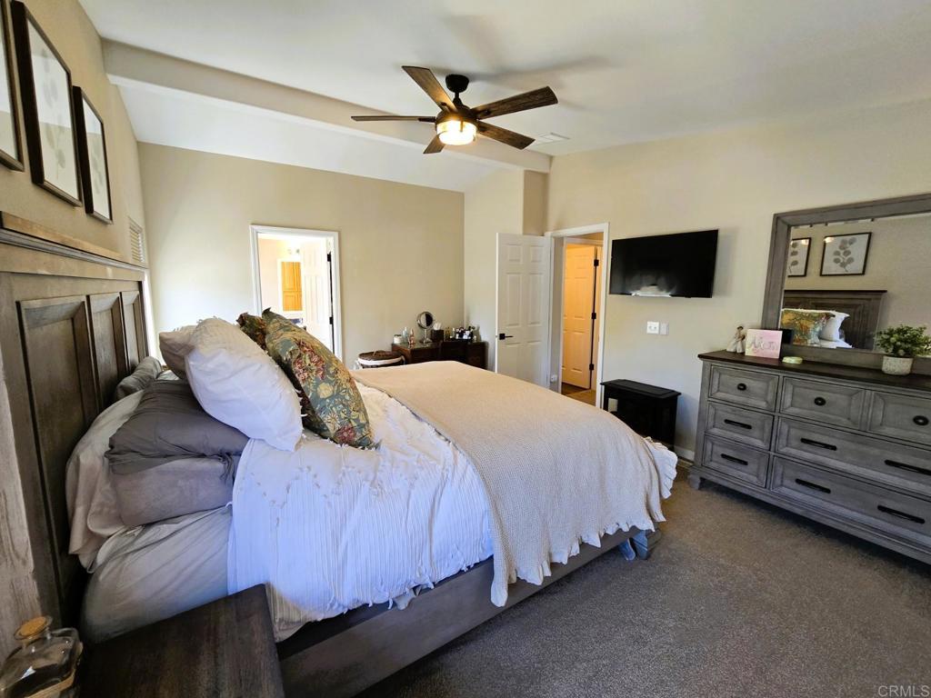 2239 Black Canyon Road, Unit 55 Ramona, CA 92065 - Photo 26 of 38 a bedroom with a bed and a flat screen tv