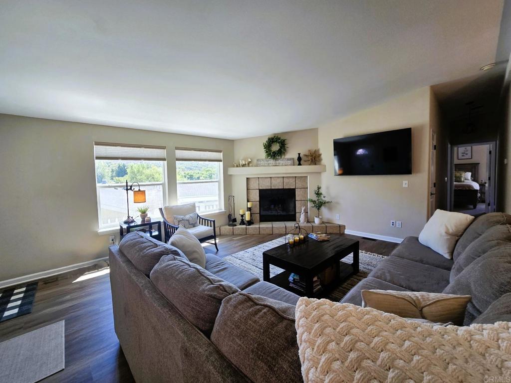 2239 Black Canyon Road, Unit 55 Ramona, CA 92065 - Photo 4 of 38 a living room with furniture a flat screen tv and a fireplace
