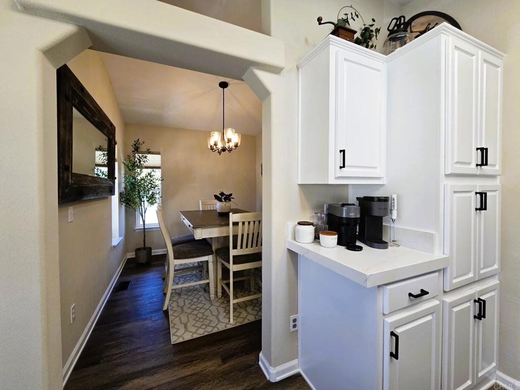 2239 Black Canyon Road, Unit 55 Ramona, CA 92065 - Photo 8 of 38 a kitchen with a table chairs refrigerator and cabinets