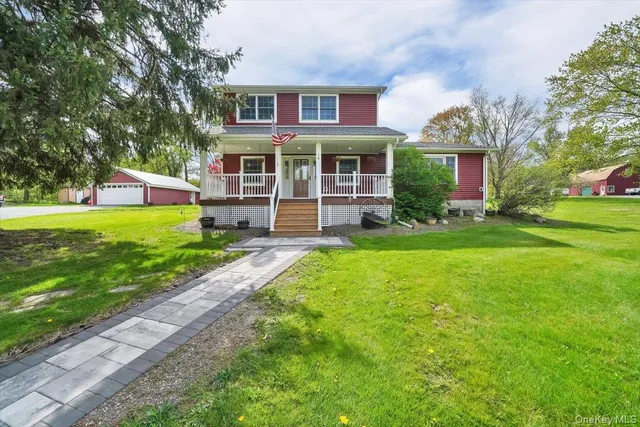a front view of a house with a yard table and chairs