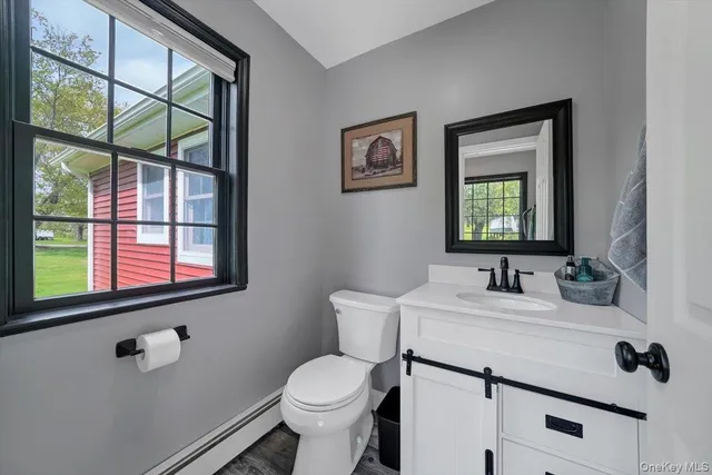 a bathroom with a toilet sink and mirror