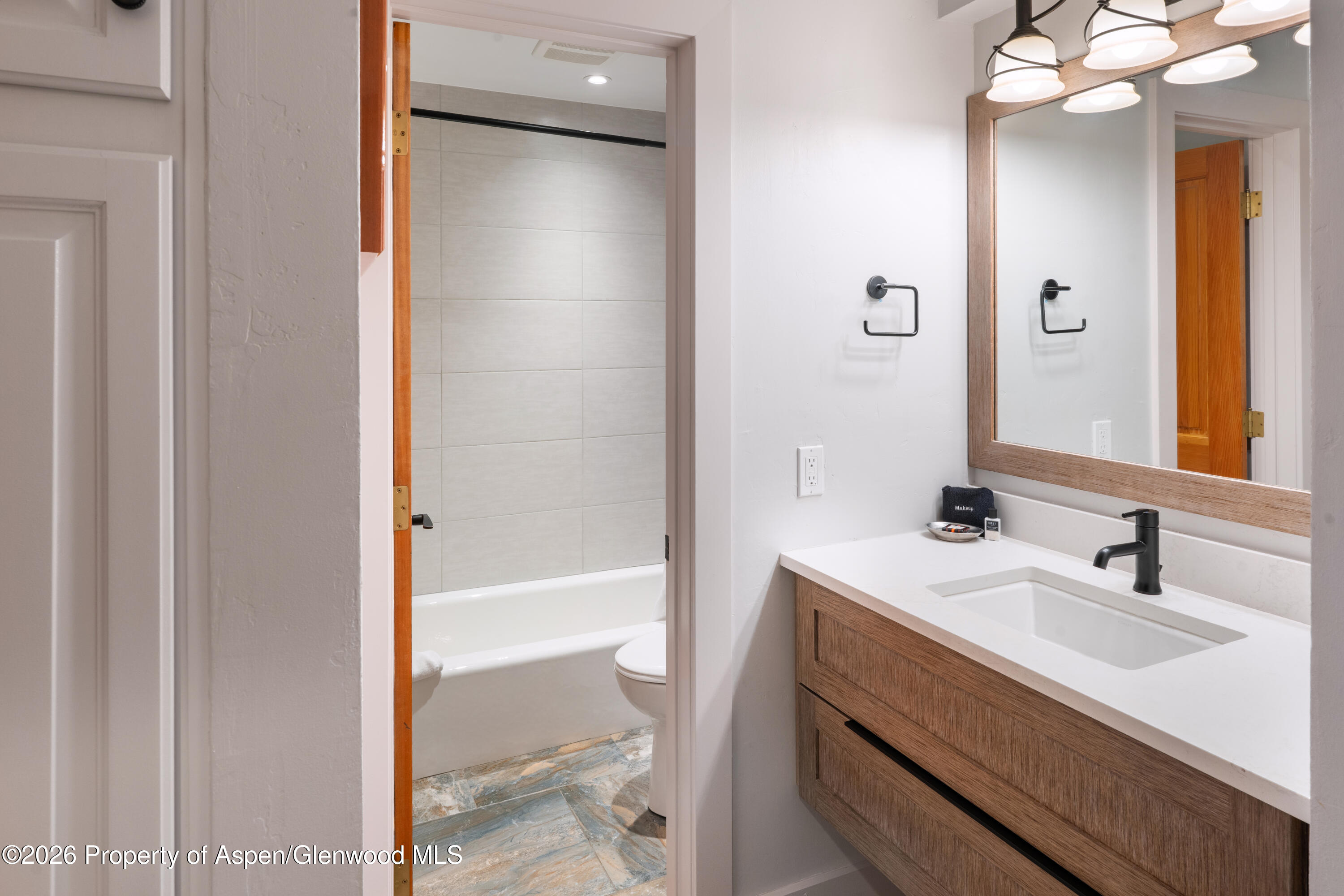 400 Wood Road, Unit 2111H Snowmass Village, CO 81615 - Photo 12 of 16 a bathroom with a sink a vanity and a mirror