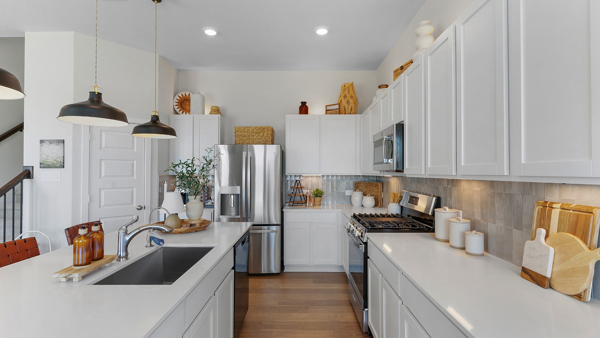 25812 Jasmine Sprig Lane Elgin, TX 78621 - Photo 7 of 33 Culinary adventures await in this naturally illuminated kitchen, boasting a spacious island and top-tier stainless steel appliances.