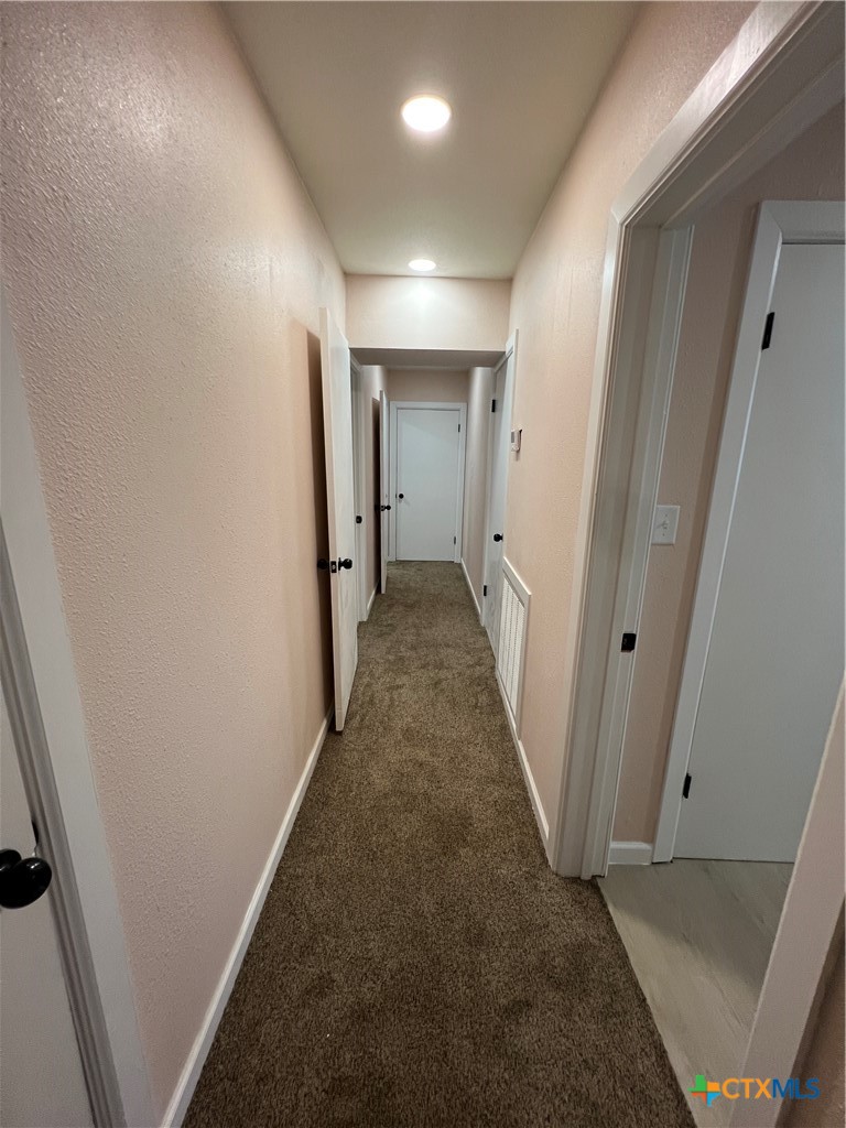 1009 Oak Street Refugio, TX 78377 - Photo 13 of 22 a view of a hallway with wooden floor