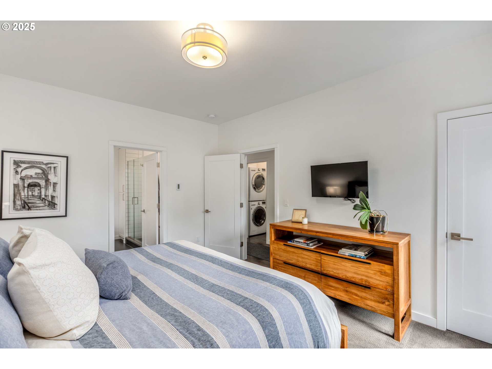 10190 Pine Ridge Drive Nehalem, OR 97131 - Photo 15 of 35 a bedroom with a bed and a flat screen tv