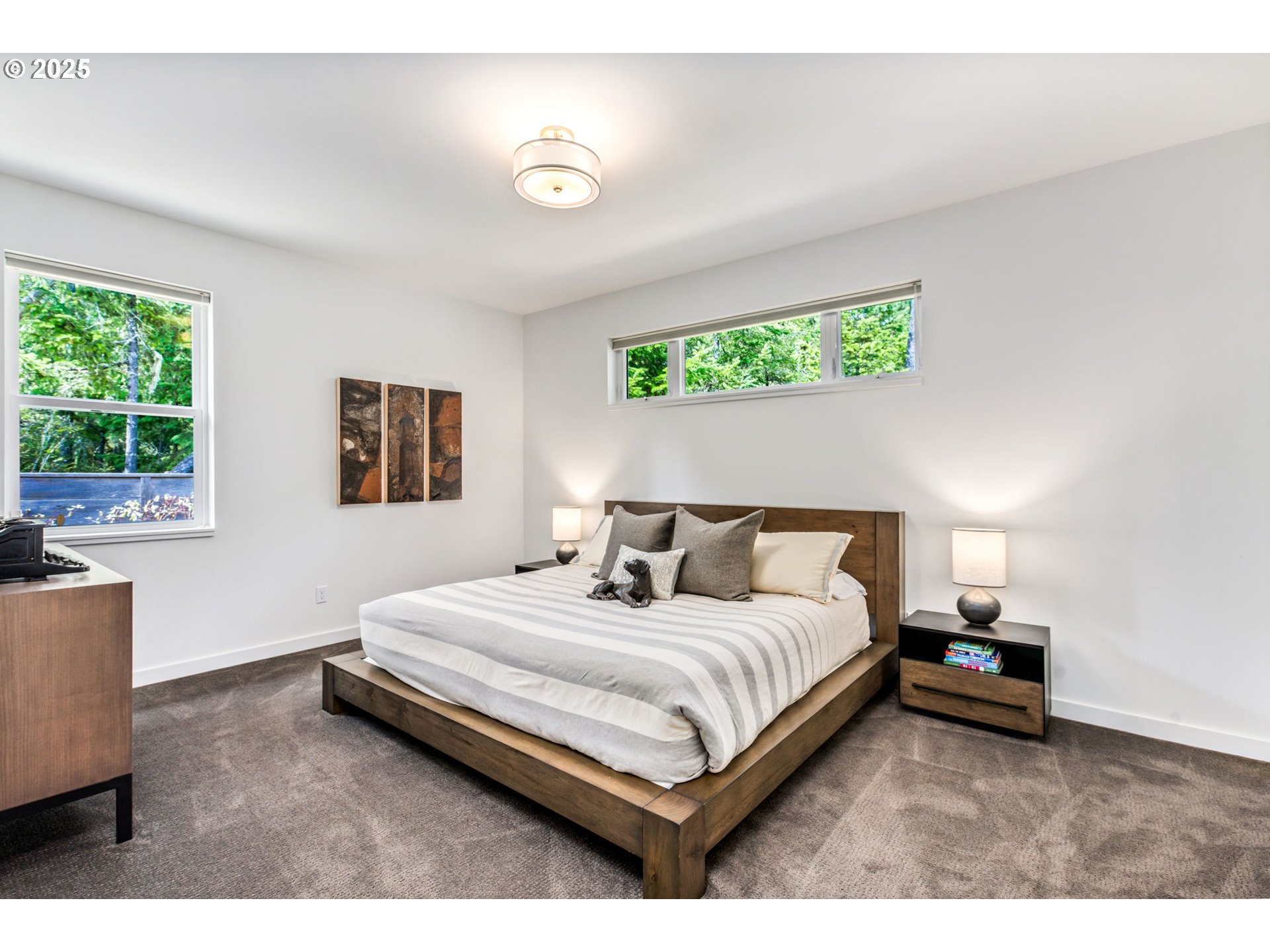 10190 Pine Ridge Drive Nehalem, OR 97131 - Photo 19 of 35 a bedroom with a bed lamp and a window