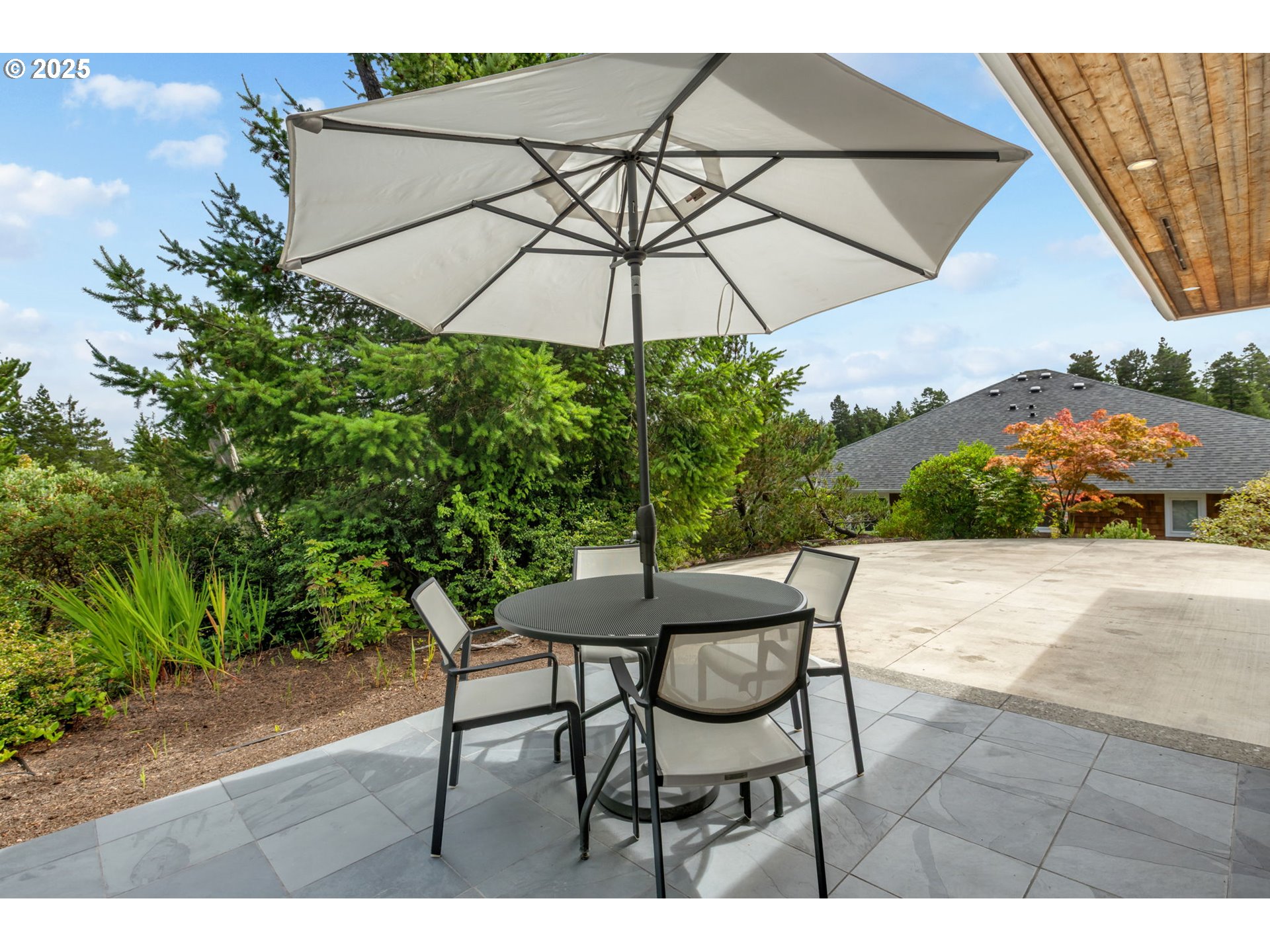 10190 Pine Ridge Drive Nehalem, OR 97131 - Photo 24 of 35 a patio with a patio table and chairs