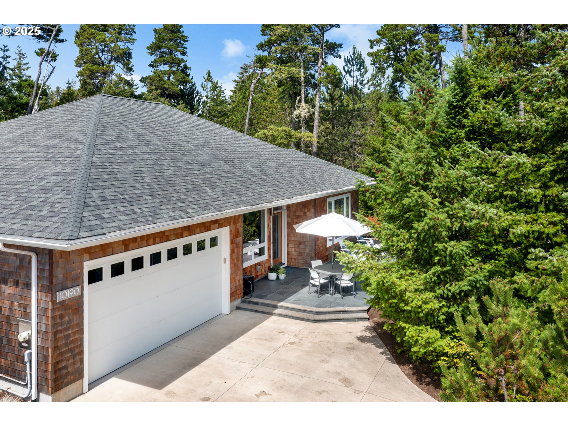 10190 Pine Ridge Drive Nehalem, OR 97131 - Photo 27 of 35 a backyard of a house with table and chairs