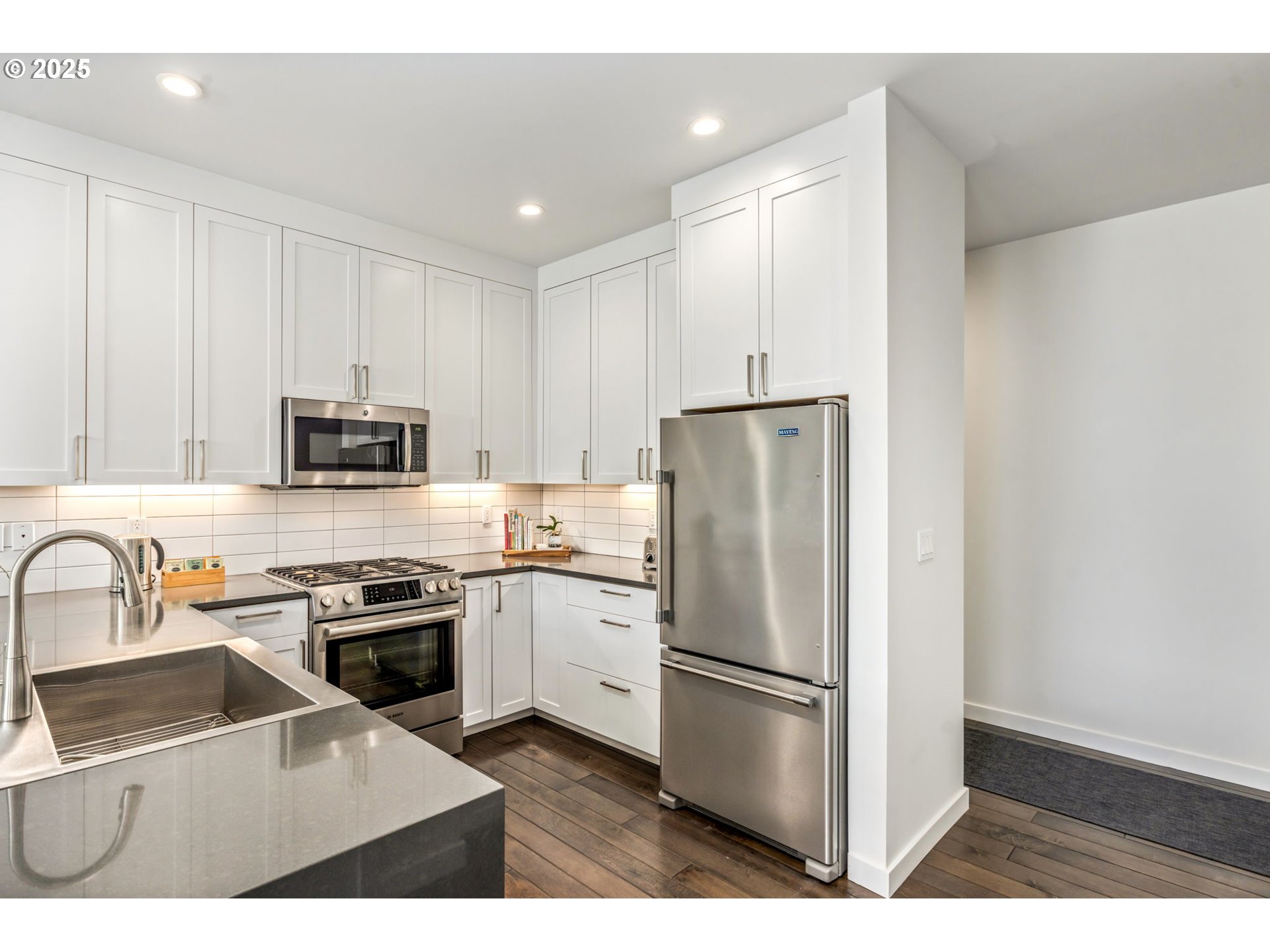 10190 Pine Ridge Drive Nehalem, OR 97131 - Photo 10 of 35 a kitchen with stainless steel appliances a refrigerator stove microwave and sink