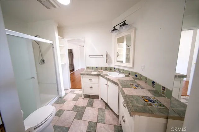 a spacious bathroom with a granite countertop sink mirror vanity and a bathtub