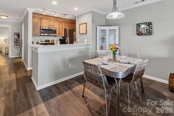 a view of a dining room with furniture and wooden floor
