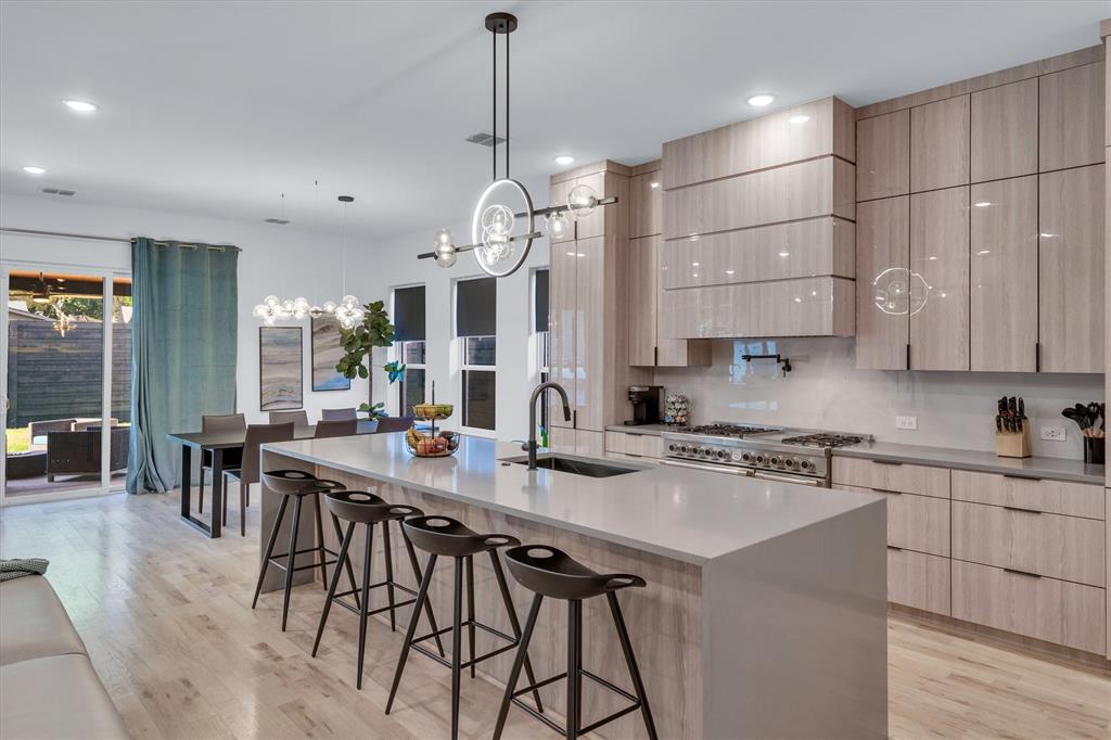 7519 Robin Road Dallas, TX 75209 - Photo 21 of 40 a kitchen with stainless steel appliances granite countertop a stove a sink a refrigerator a center island a table and chairs