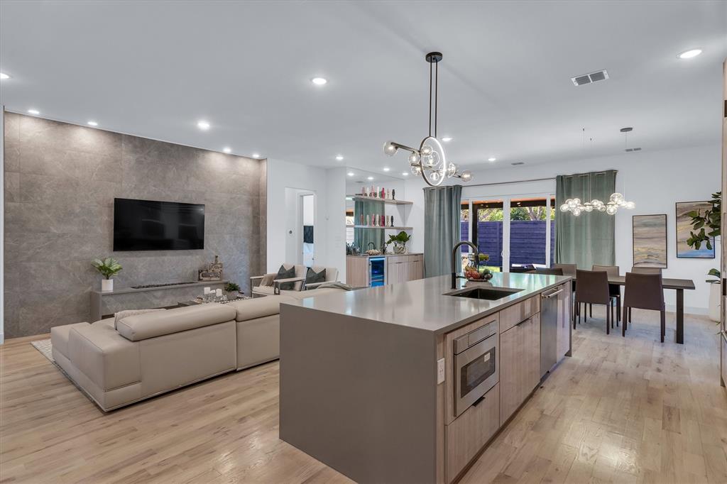 7519 Robin Road Dallas, TX 75209 - Photo 40 of 40 a living room with stainless steel appliances kitchen island furniture and a flat screen tv