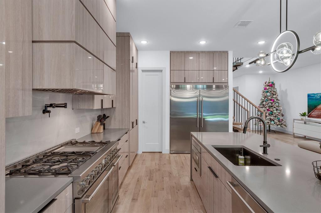 7519 Robin Road Dallas, TX 75209 - Photo 23 of 40 a kitchen with a stove a sink and a refrigerator