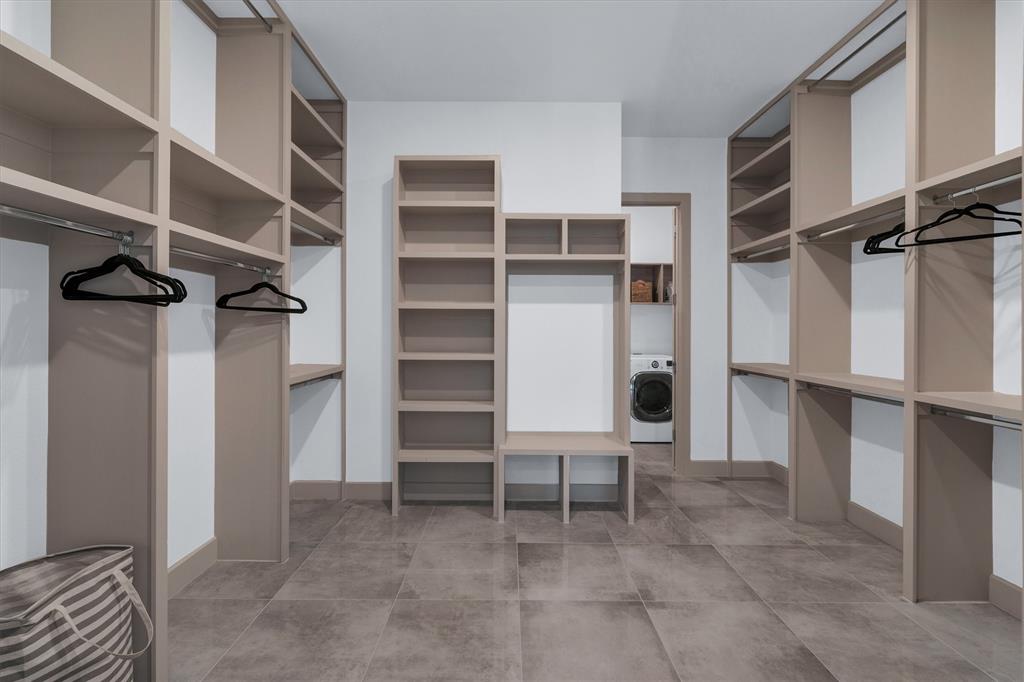 7519 Robin Road Dallas, TX 75209 - Photo 31 of 40 a view of walk in closet with clothes and shoes