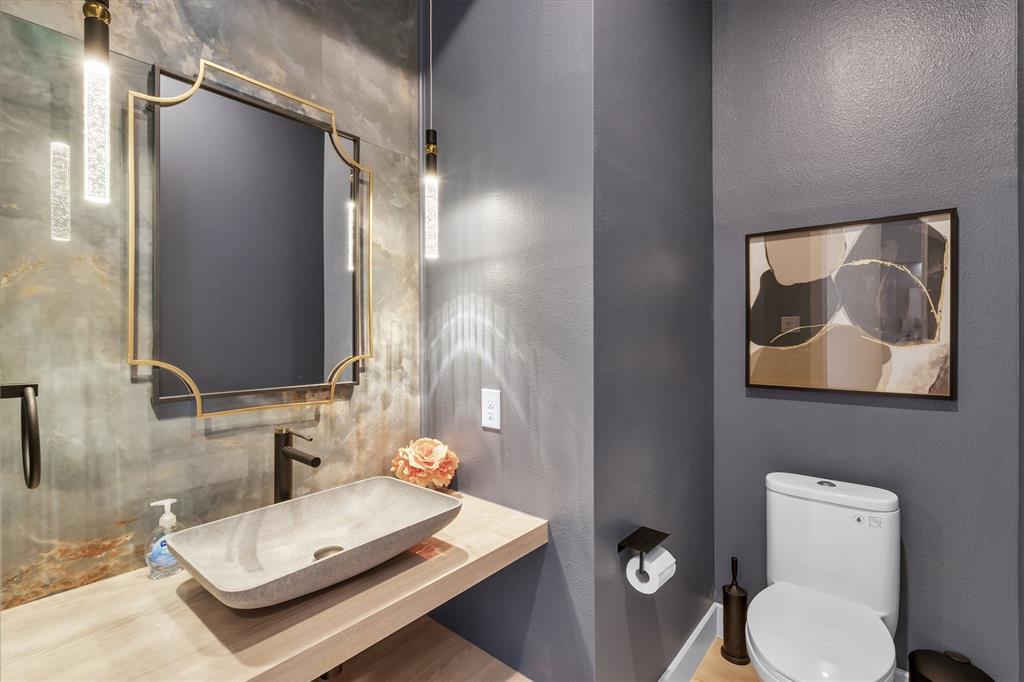 7519 Robin Road Dallas, TX 75209 - Photo 35 of 40 a bathroom with a granite countertop toilet and a sink