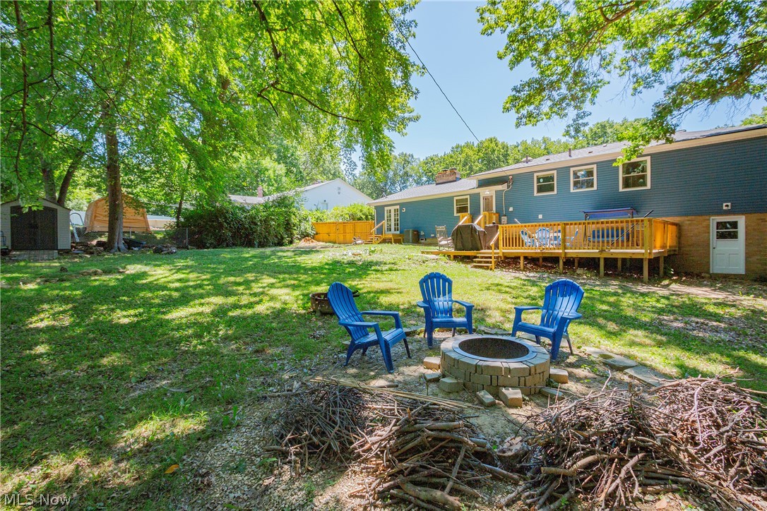 2055 Ganyard Road Akron, OH 44313 - Photo 44 of 49 View of yard with a storage shed, an outdoor fire pit, and a deck